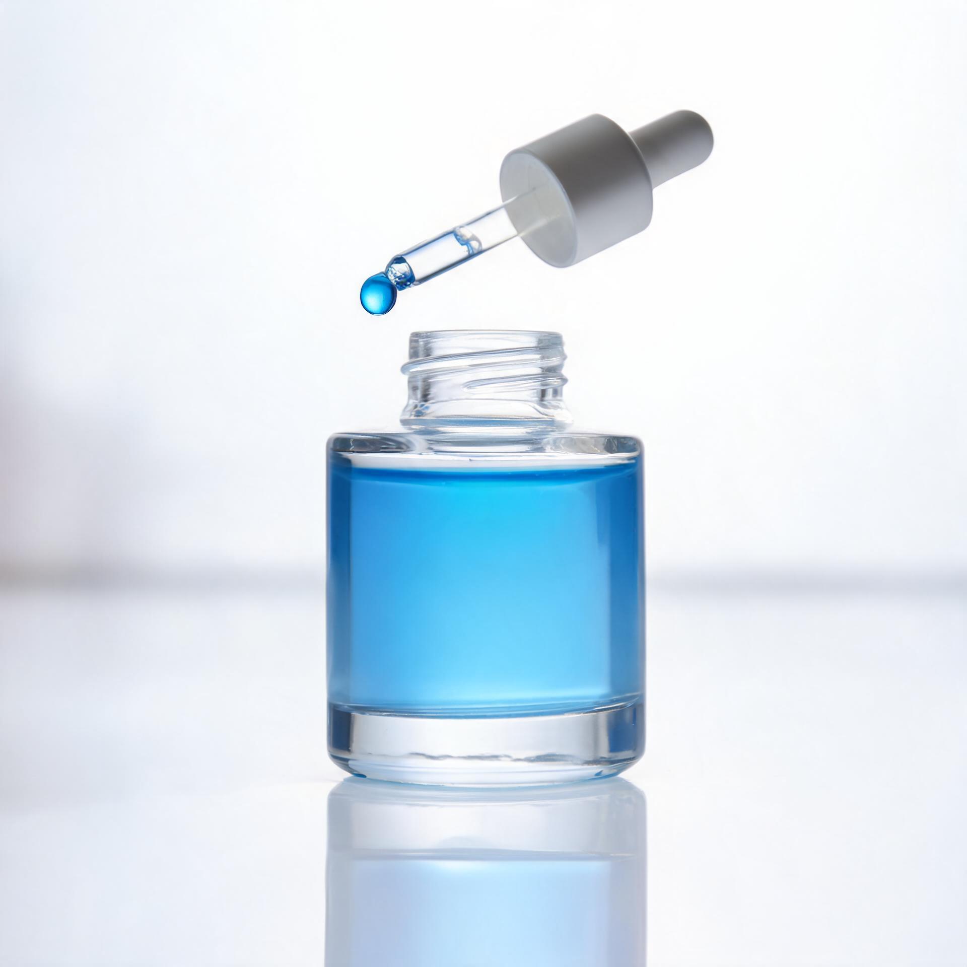 Glass bottle with dropper holding clear blue Copper Tripeptide-1 serum